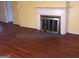 Living room highlighting hardwood floors, fireplace with white mantle, and yellow walls at 138 Le Brun Ne Rd, Atlanta, GA 30342