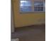 An unfinished room with yellow walls, bare concrete floors, and natural light from a window at 138 Le Brun Ne Rd, Atlanta, GA 30342