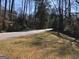 A quiet street lined with mature trees and natural landscaping at 138 Le Brun Ne Rd, Atlanta, GA 30342