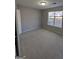 Well-lit bedroom with a window and carpet flooring at 2331 Rambling Way, Lithonia, GA 30058