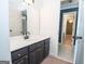 Modern bathroom with dark vanity, white sink, and hexagon tile floor at 568 Martin Mill Rd, Moreland, GA 30259