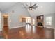 Open living room with hardwood floors, a stone fireplace, and high ceilings at 568 Martin Mill Rd, Moreland, GA 30259