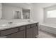 Bathroom with double vanity, marble countertop, and bathtub at 11996 Conrad Cir # 128, Hampton, GA 30228