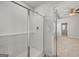 Bathroom with a walk-in shower and tiled walls at 11996 Conrad Cir # 128, Hampton, GA 30228