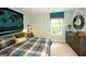 Charming bedroom with a dresser, window, and large bed at 11996 Conrad Cir # 128, Hampton, GA 30228