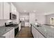 Kitchen with granite countertops and stainless steel appliances at 11996 Conrad Cir # 128, Hampton, GA 30228