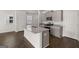 Modern kitchen with granite countertops and gray cabinets at 11996 Conrad Cir # 128, Hampton, GA 30228