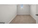 Spacious walk-in closet with double hanging rods and neutral carpeting at 11996 Conrad Cir # 128, Hampton, GA 30228