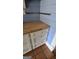 White shaker cabinets with wood countertops and simple knobs at 1786 Lakewood Se Ave, Atlanta, GA 30315