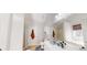 Bright bathroom featuring a large mirror, white cabinets and a bathtub at 15 Huntington Dr, Grantville, GA 30220