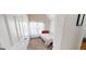 This bedroom features a twin bed and a window with white curtains that allow natural light at 15 Huntington Dr, Grantville, GA 30220