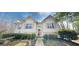 Charming home featuring symmetrical design, neutral siding, and well-maintained landscaping at 15 Huntington Dr, Grantville, GA 30220
