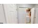Functional laundry area with washer, dryer, and storage shelves at 15 Huntington Dr, Grantville, GA 30220