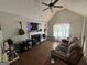 Living room with a fireplace, TV, ceiling fan, and large window at 15 Huntington Dr, Grantville, GA 30220