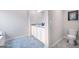 Bathroom with double vanity, large mirror, and gray tile flooring at 12046 Conrad Cir # 100, Hampton, GA 30228