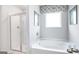 Bathroom with garden tub, shower, and window with valance at 12046 Conrad Cir # 100, Hampton, GA 30228