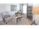 Bright home office featuring a writing desk, comfortable armchair, and a modern bookshelf at 12046 Conrad Cir # 100, Hampton, GA 30228