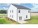 Two story house featuring a patio, landscaping and white siding at 12046 Conrad Cir # 100, Hampton, GA 30228