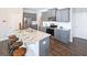 Modern kitchen with gray cabinets, granite countertops and island with seating at 12046 Conrad Cir # 100, Hampton, GA 30228