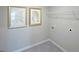 Clean laundry room with tile flooring, shelving, and space for a washer and dryer at 12046 Conrad Cir # 100, Hampton, GA 30228