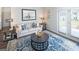 Cozy living room featuring a neutral sofa and blue rug at 12046 Conrad Cir # 100, Hampton, GA 30228