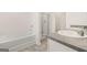 Bathroom with bathtub shower combo and gray tile floor at 12116 Conrad Cir # 114, Hampton, GA 30228