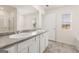 Double vanity bathroom with gray countertop and tile floor at 12116 Conrad Cir # 114, Hampton, GA 30228