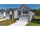 Two-story house with gray siding, and a two-car garage at 12116 Conrad Cir # 114, Hampton, GA 30228