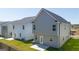 Two-story home with gray siding, back patio, and grassy yard at 12116 Conrad Cir # 114, Hampton, GA 30228