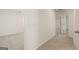 Carpeted hallway with doors to bedrooms at 12116 Conrad Cir # 114, Hampton, GA 30228