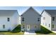 Rear view of two-story home with patio and gray siding at 12116 Conrad Cir # 114, Hampton, GA 30228