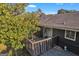Back deck featuring wood railings, a sliding glass door and home's exterior with dark siding at 2145 Sandgate Cir, South Fulton, GA 30349