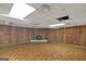 Basement with wood paneling and brick fireplace at 2145 Sandgate Cir, South Fulton, GA 30349