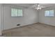 Bedroom with neutral carpet, two windows, and a ceiling fan with lights at 2145 Sandgate Cir, South Fulton, GA 30349