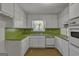 U-shaped kitchen featuring white cabinets and green countertops at 2145 Sandgate Cir, South Fulton, GA 30349