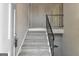 Carpeted staircase with white walls and a black metal railing at 2145 Sandgate Cir, South Fulton, GA 30349