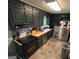Cozy kitchen featuring dark cabinetry, stainless steel appliances, and butcher block countertops, creating a rustic charm at 2497 Old Jackson Rd, Locust Grove, GA 30248