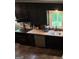 Cozy kitchen featuring dark cabinetry, stainless steel appliances, and butcher block countertops, creating a rustic charm at 2497 Old Jackson Rd, Locust Grove, GA 30248