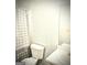 The bathroom features a toilet, sink and mirror, with a shower/tub and curtain at 261 Coral Cir, Mcdonough, GA 30253