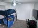This bedroom features a bunk bed and a desk with a wall-mounted TV at 261 Coral Cir, Mcdonough, GA 30253