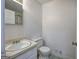 Bathroom with a sink with mirror above, toilet and linoleum floor at 731 Willow Ridge Dr, Marietta, GA 30068