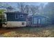 Exterior showing a two-story home with blue siding, white foundation and a leafy backyard with small tree at 422 Windsor Dr, Forest Park, GA 30297