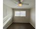 Neutral bedroom featuring light walls, ceiling fan, window with blinds, and vinyl plank flooring at 422 Windsor Dr, Forest Park, GA 30297