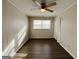 Neutral bedroom featuring plank flooring, fan and window at 422 Windsor Dr, Forest Park, GA 30297