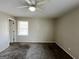 Neutral bedroom featuring carpet flooring, fan and window at 422 Windsor Dr, Forest Park, GA 30297
