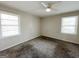 Neutral bedroom featuring carpet flooring, fan and two windows at 422 Windsor Dr, Forest Park, GA 30297