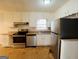 Bright kitchen featuring stainless steel appliances, white cabinets, and tile flooring at 422 Windsor Dr, Forest Park, GA 30297