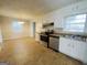 Bright eat in kitchen with stainless steel appliances and a view of the adjacent dining room at 422 Windsor Dr, Forest Park, GA 30297