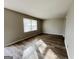 Bright living room with wood-look floors and neutral walls with lots of natural light at 422 Windsor Dr, Forest Park, GA 30297