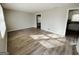 Bright living room with wood-look floors leading to kitchen with neutral walls at 422 Windsor Dr, Forest Park, GA 30297